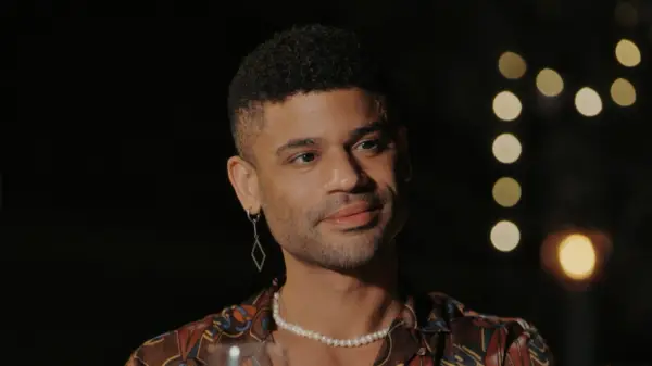 A close-up of Keye, smiling ahead.