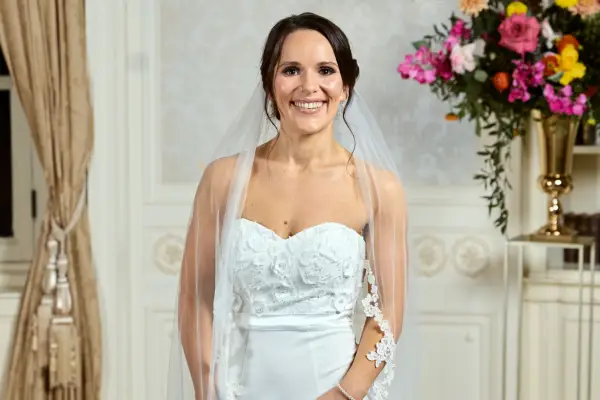 An image of Grace on her wedding day, wearing a white dress and veil.