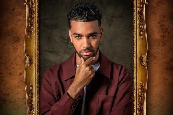 Niko Omilana in a framed image, looking ahead with his chin resting on his hand.