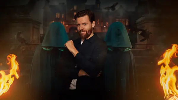 Paul for The Traitors season 2. Paul has his back turned with one arm risen