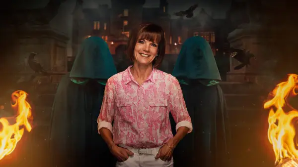 Diane for The Traitors season 2. She is wearing a pink shirt and cream trousers with her hands in her pockets