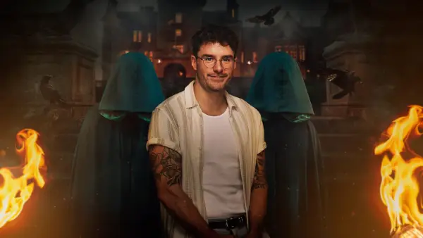 Brian for The Traitors season 2. Brian is wearing a stripy unbuttoned shirt with a white-shirt beneath and glasses