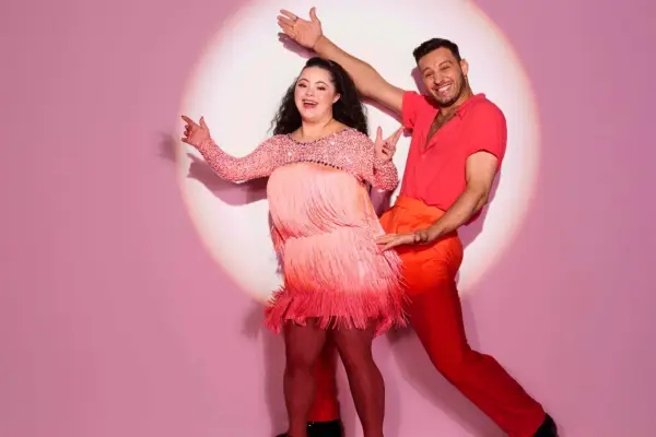 Ellie Goldstein and Vito Coppola dancing as they pose for a photo.