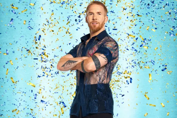 Neil Jones posing with his arms folded ahead of him.