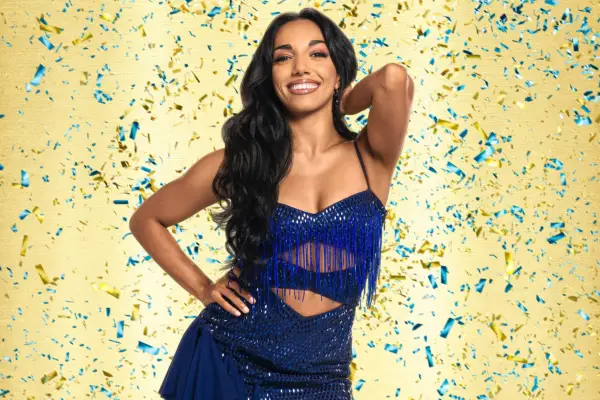 Michelle Tsiakkas wearing a blue dress, smiling ahead.