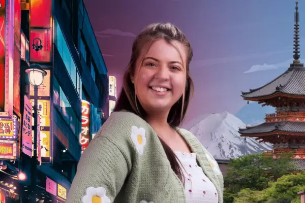 Woman with brown hair and green flower cardigan smiles at camera with scene of Japan behind her.