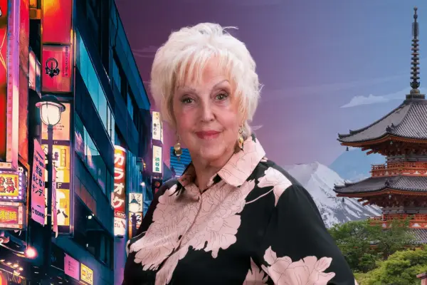Pensioner with blonde hair and large gold earrings looks at camera with scene of Japan behind her.