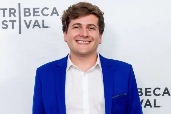 Jeremy Culhane smiling, wearing a white shirt and blue blazer.