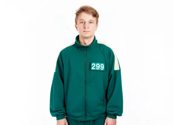 Squid Game: The Challenge player Spencer wearing a green tracksuit with 299 on his chest