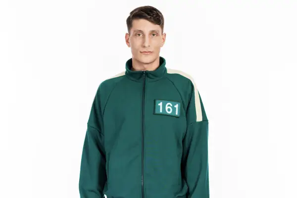 Squid Game: The Challenge player Lorenzo wearing a green tracksuit with 161 on his chest