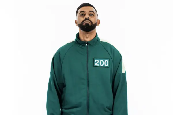 Squid Game: The Challenge player Mothi wearing a green tracksuit with 200 on his chest