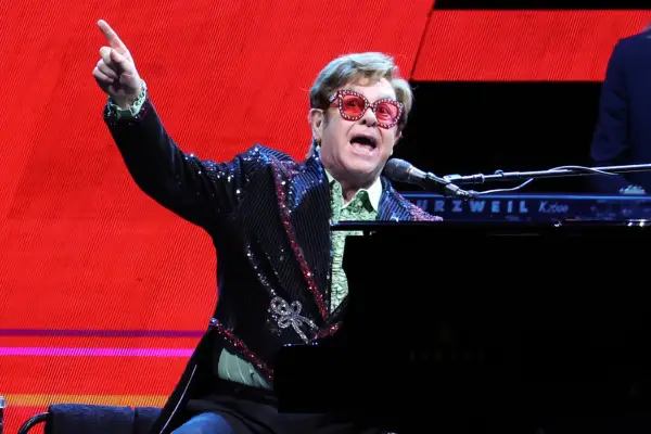 Elton John performing at the piano
