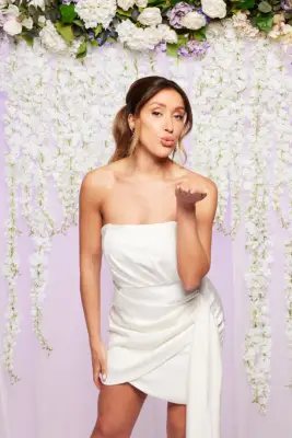 Shona from Married at First Sight UK 2023 wearing a white dress blowing a kiss