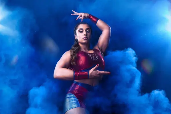 Athena for Gladiators. She is posing and surrounded by blue smoke