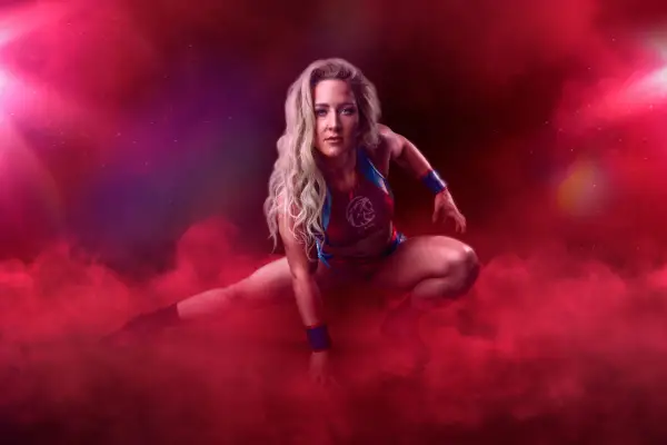 Sabre AKA Sheli McCoy stood low down looking ahead as she is surrounded by red smoke