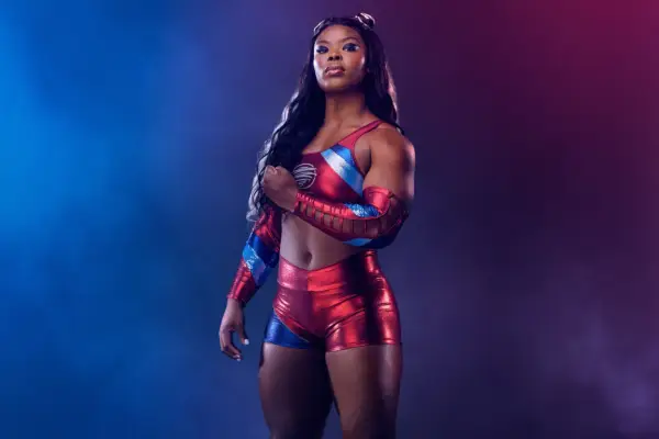 Cyclone wearing a red and blue latex outfit, holding one fist up.