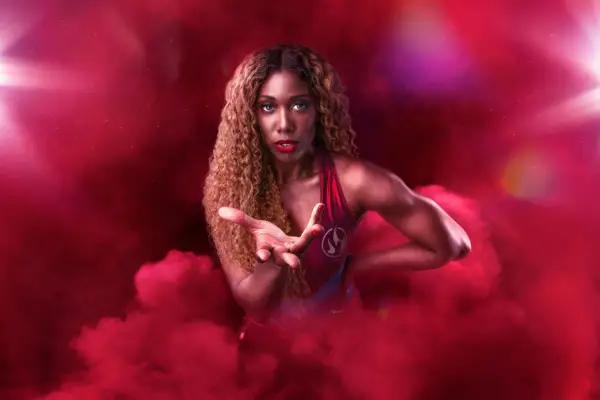 Fire AKA Montell Douglas for Gladiators. She is surrounded by Red Smoke
