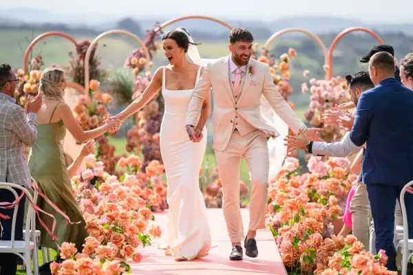 Sierah and Billy on their wedding day, holding hands.