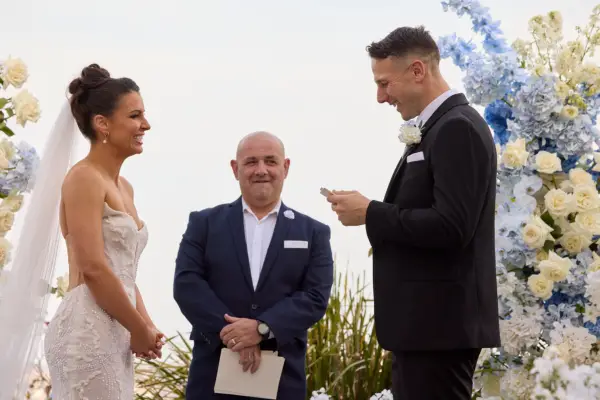 Rhi and Jeff stood opposite each other, laughing and smiling.