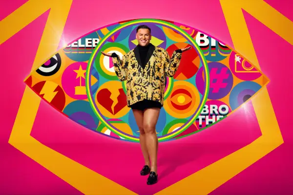 Celebrity Big Brother 2024 contestant David Potts wearing a printed blazer while posing in front of the iconic Big Brother eye logo.