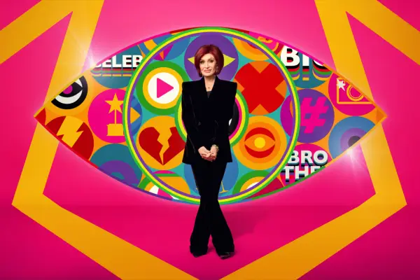 Sharon Osbourne wearing a black suit standing in front of the iconic Big Brother eye for Celebrity Big Brother 2024.