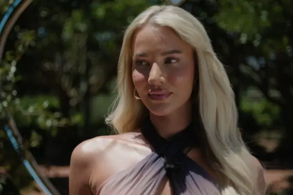 Grace Jackson wearing a halterneck swimsuit, looking to the side.