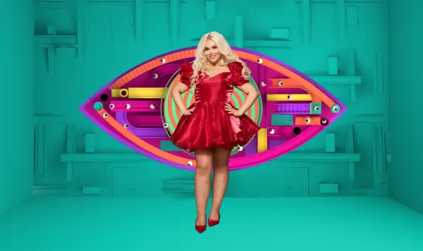 Jenny smiling ahead with her hands on her hips, wearing a red party dress.