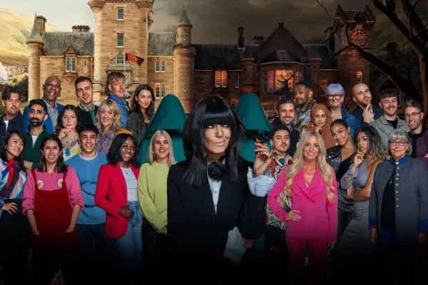The cast of The Traitors, smiling and posed ahead. Claudia Winkleman is imposed in the middle of the players.