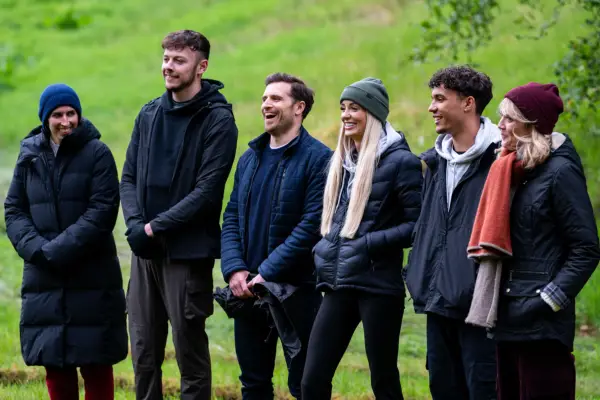 Charlotte, Jake, Alexander, Leanne, Freddie and Alexander stood n a row in winter clothing, laughing and smiling.