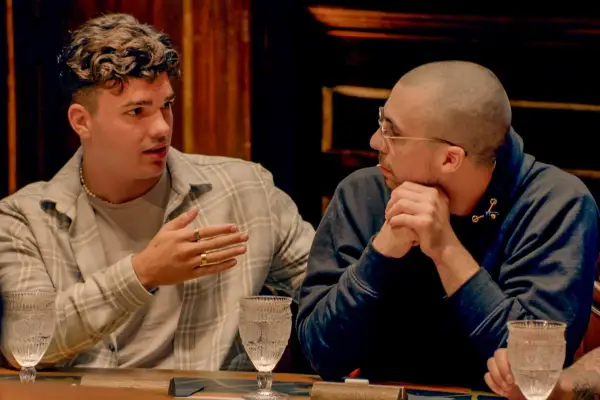 Harry and Zack having a discussion at the roundtable
