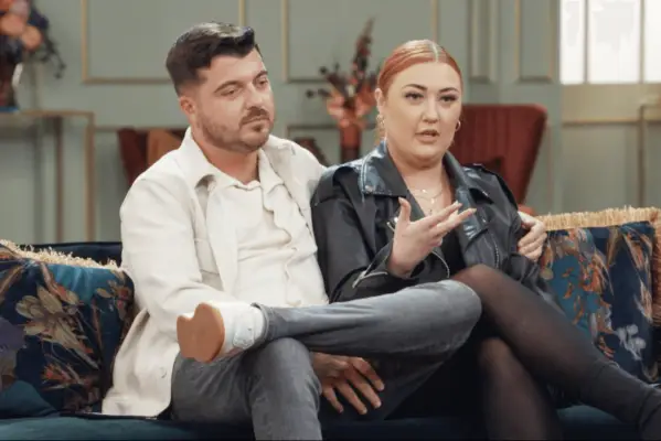 Emma and Caspar holding hands, laughing and smiling.