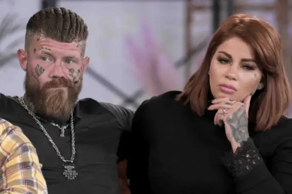 Alex and Holly both smiling as they sit next to each other.