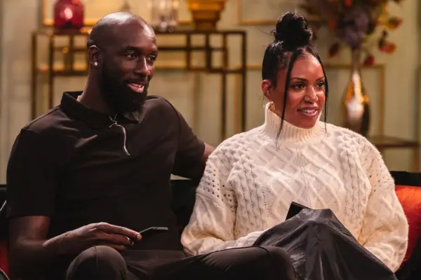 Orson and Richelle sat down next to each other, smiling.