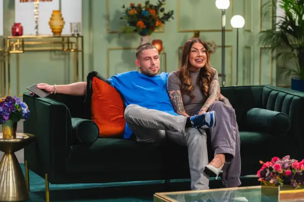 Sionainn and Ryan sat down next to each other, smiling ahead.