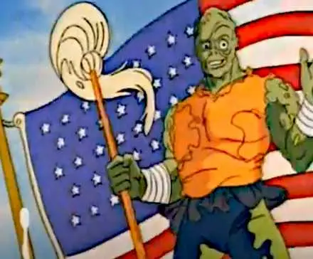 Toxie stands smiling before a large United States flag in 