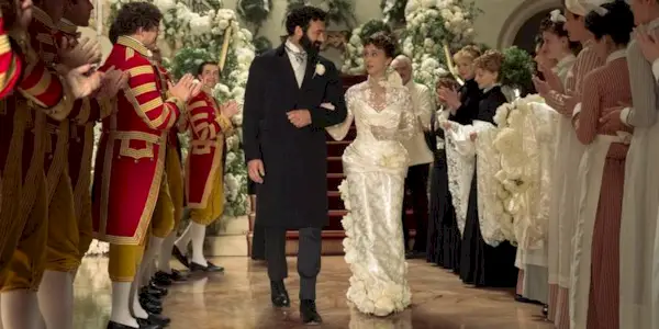 Taissa Farmiga being walked down the aisle at her wedding by Morgan Spector in The Gilded Age Season 3.