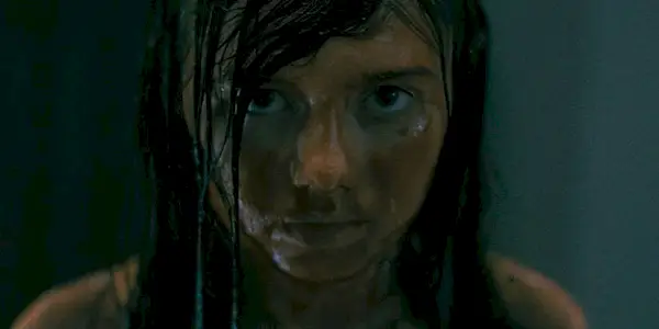 Violet McGraw covered in blood looking at camera in The Curse of the Necklace