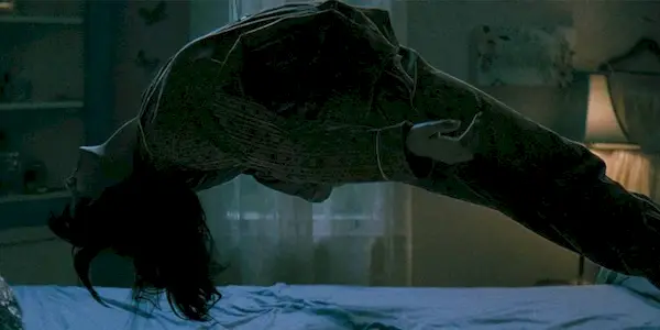 Still of someone rising up off a bed in The Curse of the Necklace