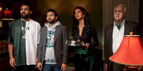 Raj, Mir, Auntie Lucky and Ahmed Uncle listening to Lazano off-screen in a scene from Deli Boys Season 1.