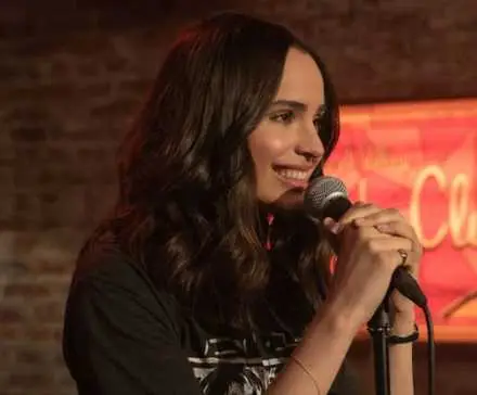 Sofia Carson holding a microphone in 
