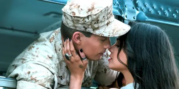 Sofia Carson as Cassie about to kiss Nicholas Galitzine as Luke in uniform in Purple Hearts