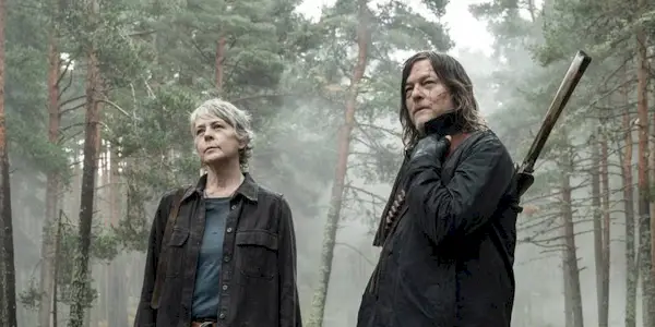 Norman Reedus and Melissa McBride standing in a forest in The Walking Dead Daryl Dixon