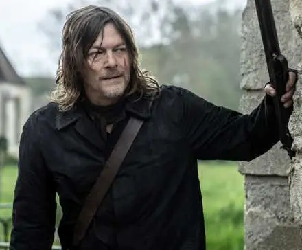 Norman Reedus as Daryl holding a rifle against a wall in The Walking Dead: Daryl Dixon Season 2