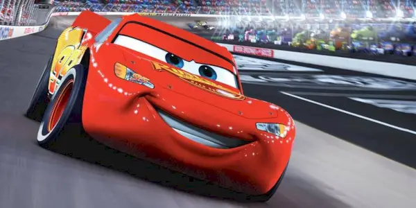 Lightning McQueen, voiced by Owen Wilson, speeding around a racetrack in Cars