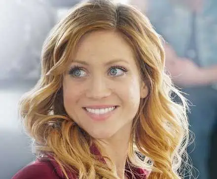 Brittany Snow smiling at something off camera in Pitch Perfect 3