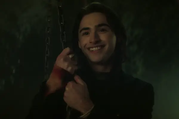 Joshua Colley as Monty in Dead Boy Detectives, smiling at something off screen