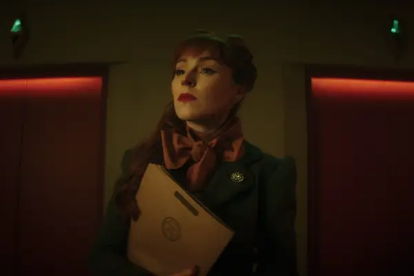 Ruth Connell as Night Nurse in Dead Boy Detectives, holding a clipboard