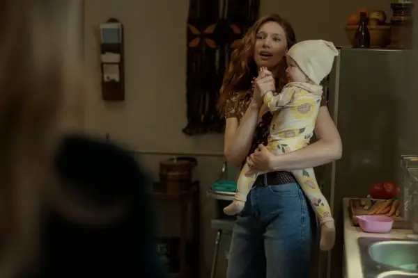 Katie Parker as Annabel Lee in The Fall of the House of Usher holding a baby