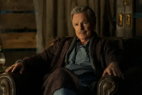 Bruce Greenwood as Roderick Usher in The Fall of the House of Usher wearing pyjamas and a dressing gown, sat in a chair