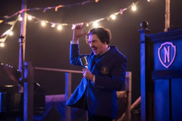 Steve Buscemi as Barry Dort in Wednesday season 2 standing on stage